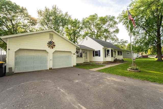 1116 Lagrange Ave, Tomah, WI 54660 - single story home featuring asphalt driveway, a garage, and a front lawn
