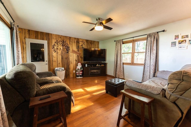1116 Lagrange Ave, Tomah, WI 54660 - living area featuring wood walls, ceiling fan, and wood finished floors