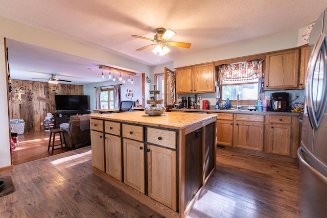 1116 Lagrange Ave, Tomah, WI 54660 - kitchen with ceiling fan, wooden counters, dark wood-style flooring, freestanding refrigerator, and wood walls
