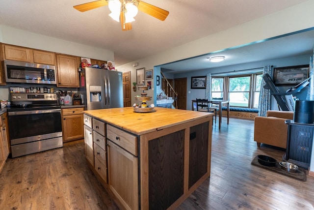 1116 Lagrange Ave, Tomah, WI 54660 - kitchen featuring stainless steel appliances, dark wood-type flooring, a ceiling fan, a kitchen island, and wood counters