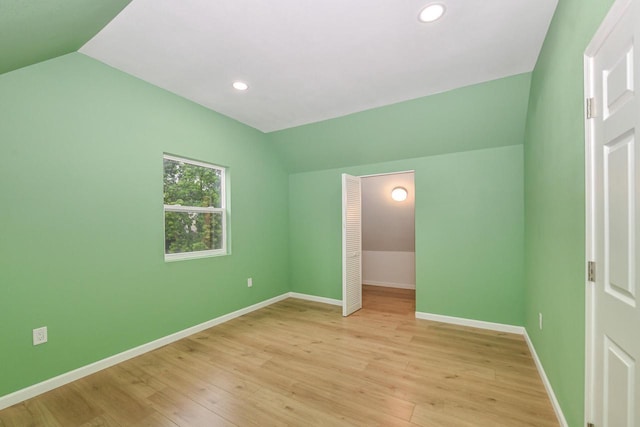 1963 S 20th St, Milwaukee, WI 53204 - unfurnished bedroom with vaulted ceiling, light wood-style flooring, and recessed lighting