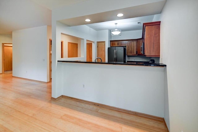 1140 E Dayton St Unit 205, Madison, WI 53703 - kitchen with stainless steel appliances, dark countertops, light wood finished floors, and recessed lighting
