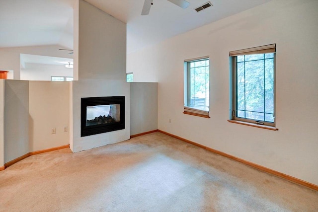 1140 E Dayton St Unit 205, Madison, WI 53703 - unfurnished living room with a ceiling fan, carpet floors, a multi sided fireplace, and lofted ceiling