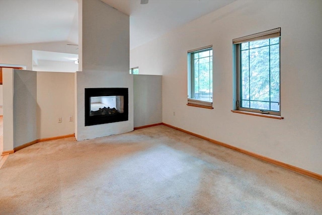 1140 E Dayton St Unit 205, Madison, WI 53703 - unfurnished living room with carpet flooring, healthy amount of natural light, lofted ceiling, and a multi sided fireplace