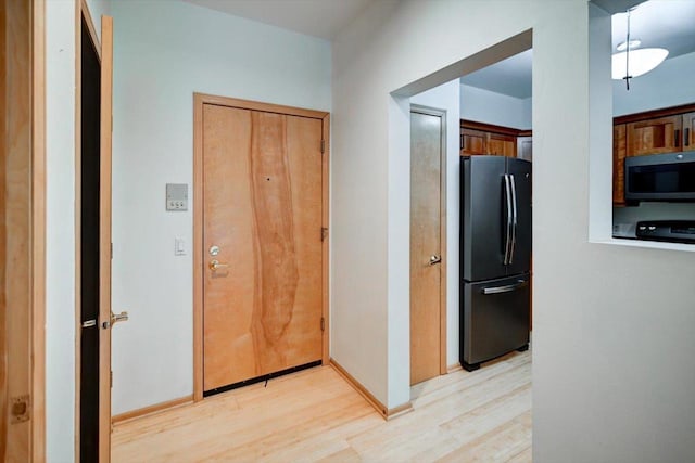 1140 E Dayton St Unit 205, Madison, WI 53703 - hallway featuring light wood-style flooring and baseboards