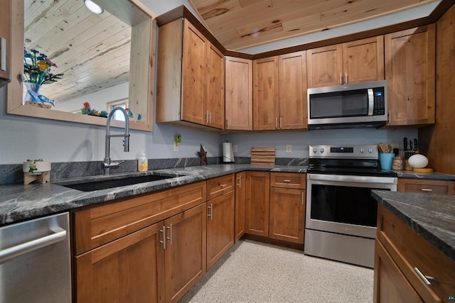 4304 E Leggate Rd, Superior, WI 54880 - kitchen with appliances with stainless steel finishes, wooden ceiling, brown cabinetry, and dark stone counters
