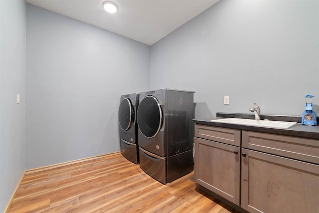 4304 E Leggate Rd, Superior, WI 54880 - laundry room featuring washer and dryer, light wood finished floors, and cabinet space