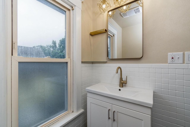 1140 Bluff St, Beloit, WI 53511 - bathroom featuring vanity, tile walls, and a chandelier