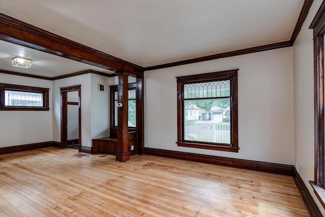 1140 Bluff St, Beloit, WI 53511 - spare room featuring light wood-type flooring, ornamental molding, and ornate columns
