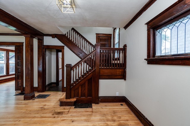 1140 Bluff St, Beloit, WI 53511 - staircase with healthy amount of natural light, ornamental molding, and wood finished floors