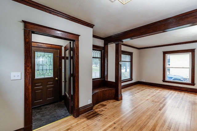 1140 Bluff St, Beloit, WI 53511 - foyer with light wood-style floors, crown molding, and ornate columns