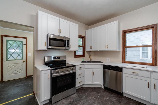 1140 Bluff St, Beloit, WI 53511 - kitchen with stainless steel appliances, white cabinets, and light countertops