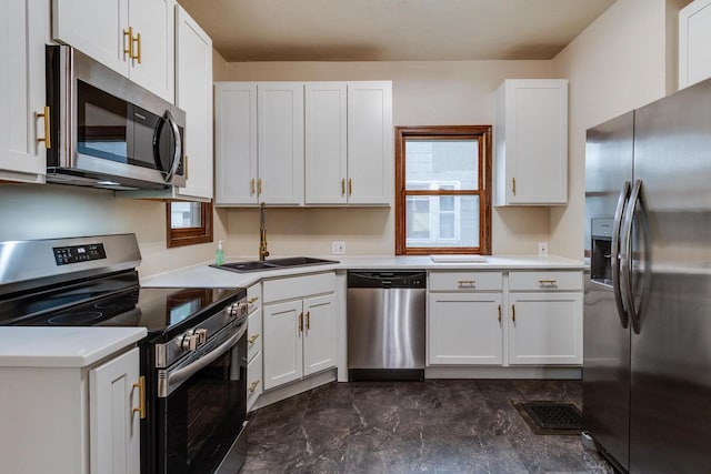 1140 Bluff St, Beloit, WI 53511 - kitchen with stainless steel appliances, light countertops, and white cabinetry