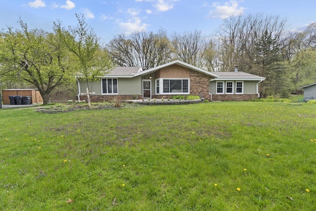 611 Mount Snowdon Rd, Wales, WI 53183 - ranch-style house with a front yard, stone siding, and a chimney