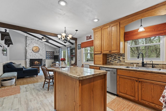 611 Mount Snowdon Rd, Wales, WI 53183 - kitchen featuring dishwasher, a fireplace, light wood-type flooring, a chandelier, and a kitchen island