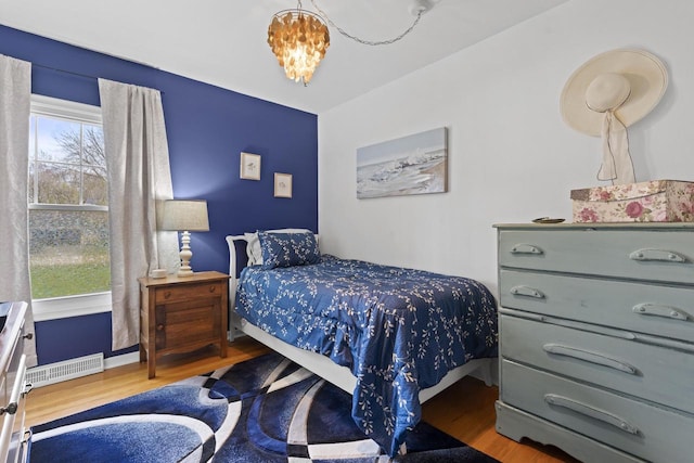611 Mount Snowdon Rd, Wales, WI 53183 - bedroom with wood finished floors and a chandelier