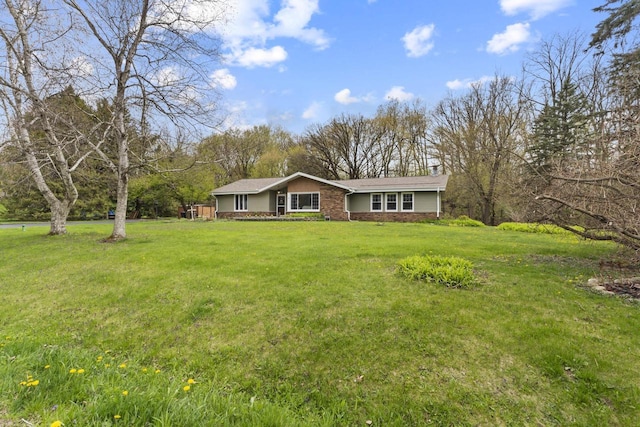 611 Mount Snowdon Rd, Wales, WI 53183 - view of front of home featuring a front yard, a chimney, and stone siding