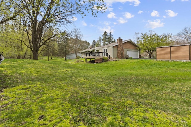 611 Mount Snowdon Rd, Wales, WI 53183 - view of green lawn featuring a wooden deck and a garage