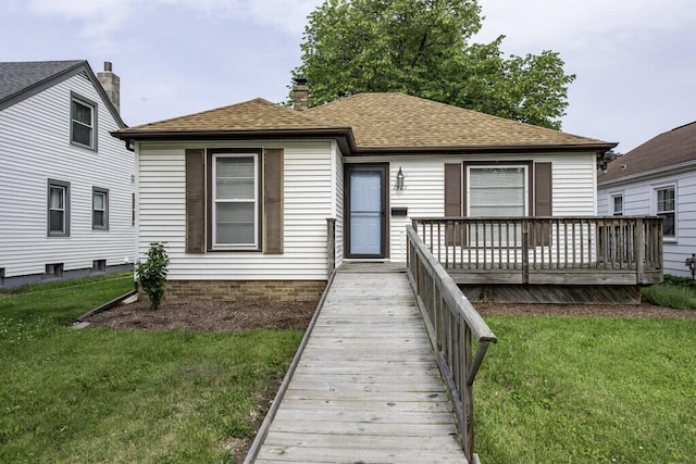 1521 Monroe Ave, Racine, WI 53405 - view of front facade featuring a front yard, a deck, roof with shingles, and a chimney