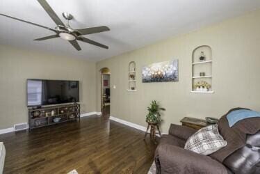 1521 Monroe Ave, Racine, WI 53405 - living area with ceiling fan, wood finished floors, built in shelves, and arched walkways