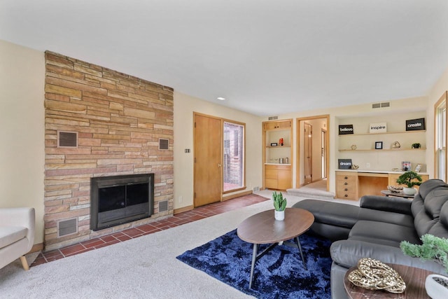 5463 N Lydell Ave, Glendale, WI 53217 - tiled living room with a stone fireplace and carpet floors