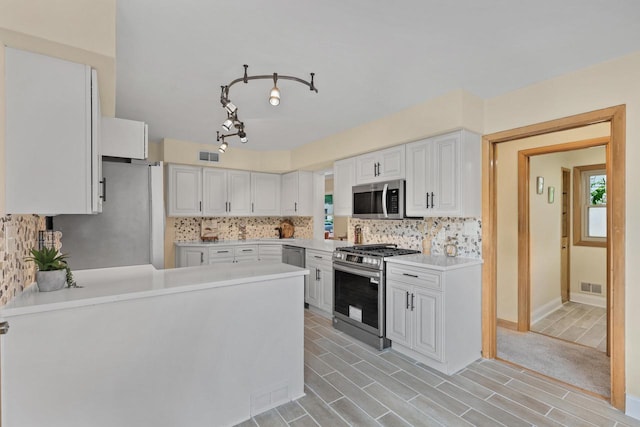 5463 N Lydell Ave, Glendale, WI 53217 - kitchen featuring stainless steel appliances, light countertops, decorative backsplash, and white cabinets
