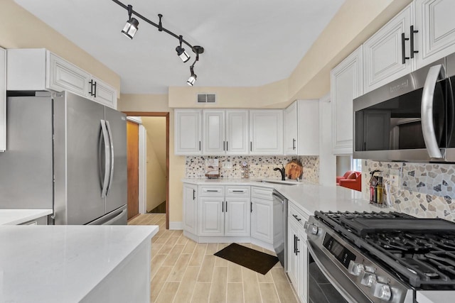 5463 N Lydell Ave, Glendale, WI 53217 - kitchen with stainless steel appliances, light countertops, white cabinets, and tasteful backsplash