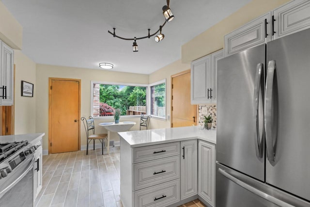 5463 N Lydell Ave, Glendale, WI 53217 - kitchen featuring stainless steel appliances, light countertops, a peninsula, and white cabinetry