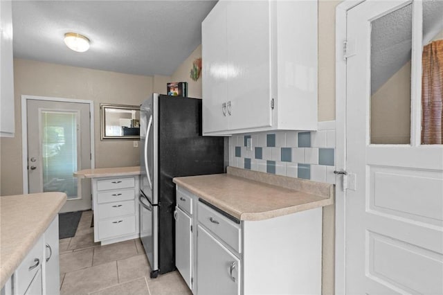 110 1st Ave, Balsam Lake, WI 54810 - kitchen with white cabinets, light countertops, light tile patterned floors, and tasteful backsplash