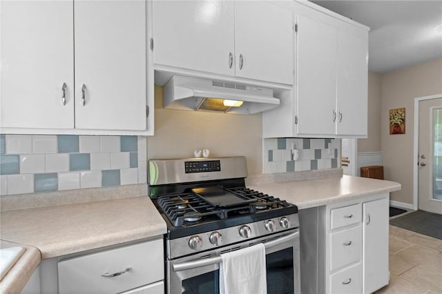 110 1st Ave, Balsam Lake, WI 54810 - kitchen with gas stove, under cabinet range hood, light countertops, and backsplash
