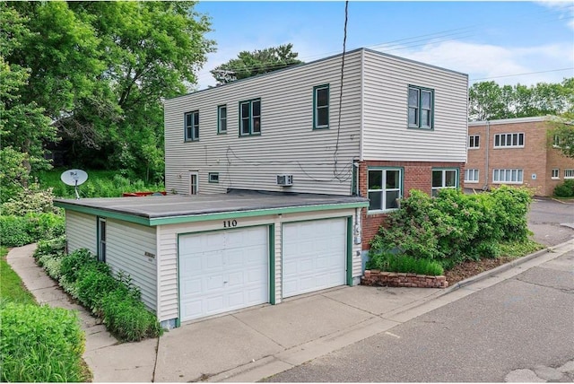 110 1st Ave, Balsam Lake, WI 54810 - view of front of property featuring a garage and brick siding