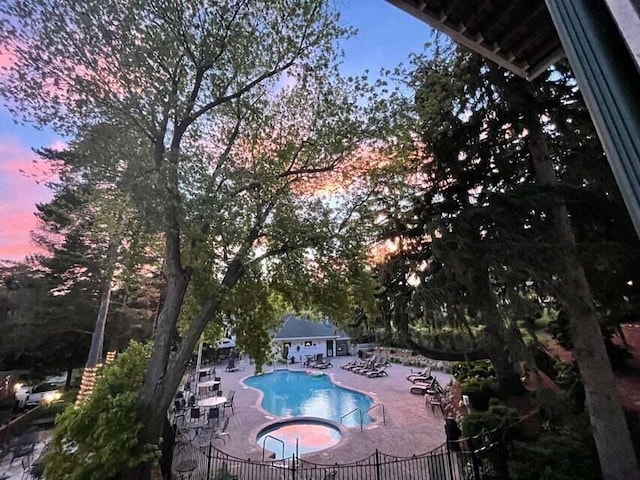 266 Victorian Village Dr Unit 226, Elkhart Lake, WI 53020 - pool at dusk with a patio and a community pool