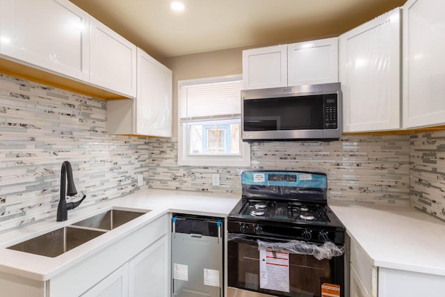 4366 N 25th St, Milwaukee, WI 53209 - kitchen featuring stainless steel appliances, tasteful backsplash, and white cabinetry