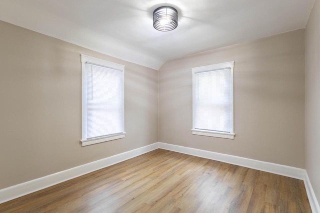 4366 N 25th St, Milwaukee, WI 53209 - spare room featuring wood finished floors and vaulted ceiling