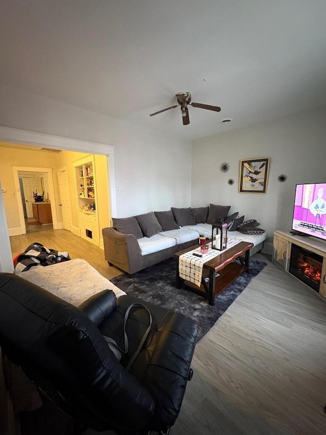 2341 S 12th St, Milwaukee, WI 53215 - living room with a ceiling fan, wood finished floors, and a glass covered fireplace