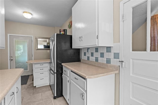 110 1st Ave, Balsam Lake, WI 54005 - kitchen with light countertops, white cabinetry, light tile patterned flooring, and tasteful backsplash
