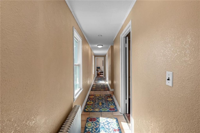 110 1st Ave, Balsam Lake, WI 54005 - hallway with radiator heating unit, a textured wall, and light tile patterned floors