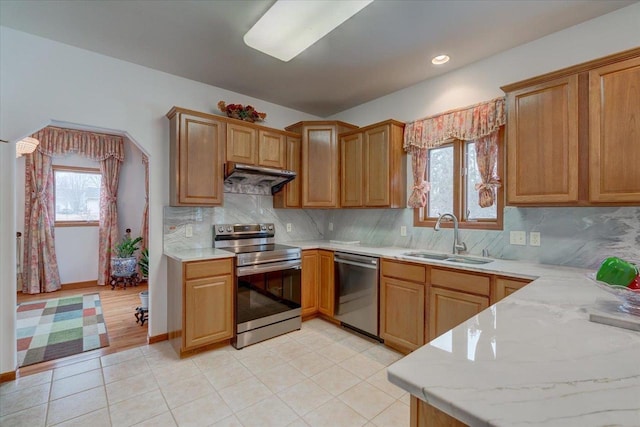 4205 Monarch Ct, Middleton, WI 53562 - kitchen with appliances with stainless steel finishes, under cabinet range hood, decorative backsplash, recessed lighting, and light tile patterned floors