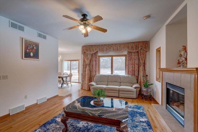 4205 Monarch Ct, Middleton, WI 53562 - living area with light wood-style flooring, ceiling fan, and a tiled fireplace