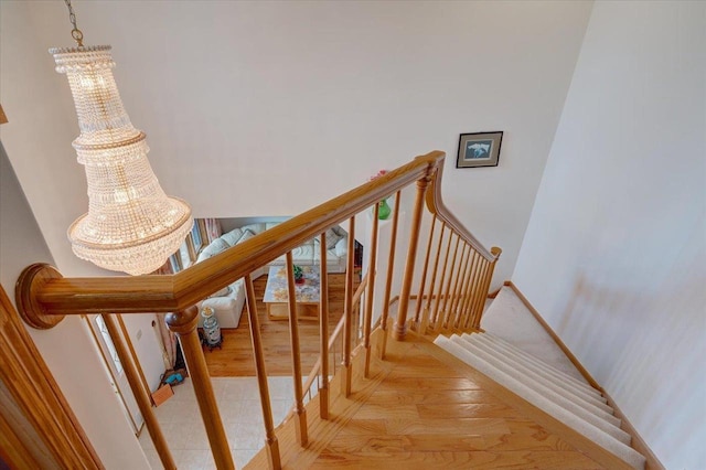 4205 Monarch Ct, Middleton, WI 53562 - stairway featuring a chandelier and wood finished floors