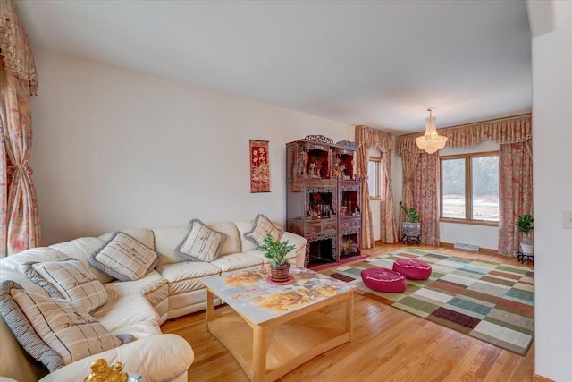 4205 Monarch Ct, Middleton, WI 53562 - living area with light wood-style flooring and a chandelier