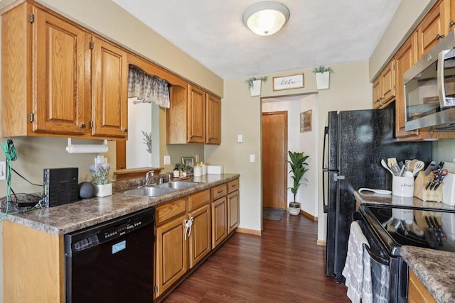 1603 Mckenna Blvd, Madison, WI 53711 - kitchen with black appliances, dark wood-style flooring, and brown cabinets