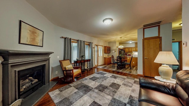 654 Riverview Ct Unit 2-Bldg C, Jefferson, WI 53549 - living room with dark wood finished floors, a fireplace, and a chandelier