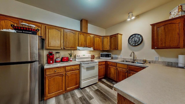 654 Riverview Ct Unit 2-Bldg C, Jefferson, WI 53549 - kitchen with white appliances, under cabinet range hood, and brown cabinetry