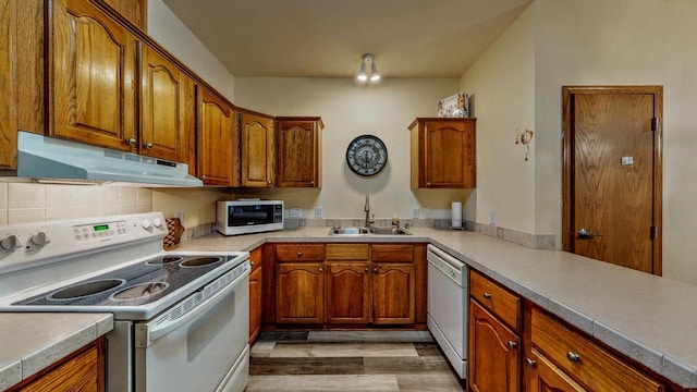 654 Riverview Ct Unit 2-Bldg C, Jefferson, WI 53549 - kitchen featuring white appliances, under cabinet range hood, light wood-style floors, and brown cabinetry