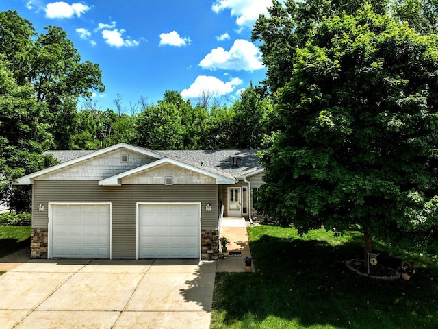 654 Riverview Ct Unit 2-Bldg C, Jefferson, WI 53549 - view of front facade with stone siding, driveway, and an attached garage