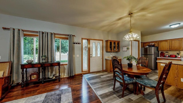 654 Riverview Ct Unit 2-Bldg C, Jefferson, WI 53549 - dining space with healthy amount of natural light, dark wood-style flooring, and a chandelier