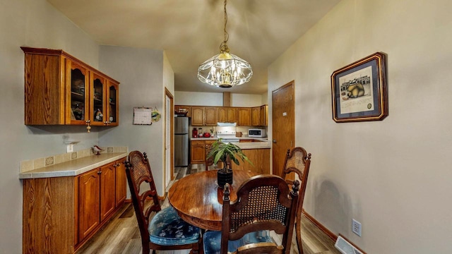 654 Riverview Ct Unit 2-Bldg C, Jefferson, WI 53549 - dining room with light wood-style floors and a chandelier