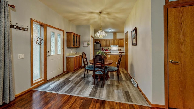 654 Riverview Ct Unit 2-Bldg C, Jefferson, WI 53549 - dining area featuring a chandelier and wood finished floors