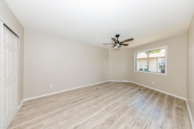 W169N11492 Biscayne Dr, Germantown, WI 53022 - unfurnished bedroom featuring light wood-style floors, a closet, and a ceiling fan